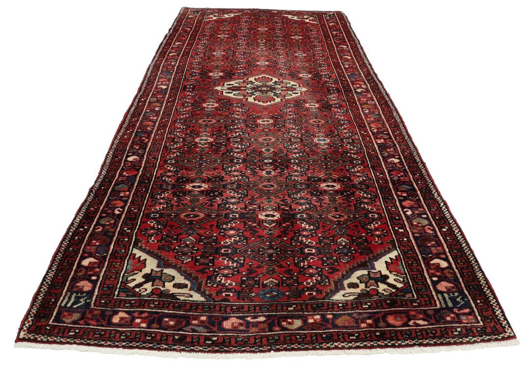 Handmade Hosseinabad runner from the Middle East with a vibrant red Wool pile