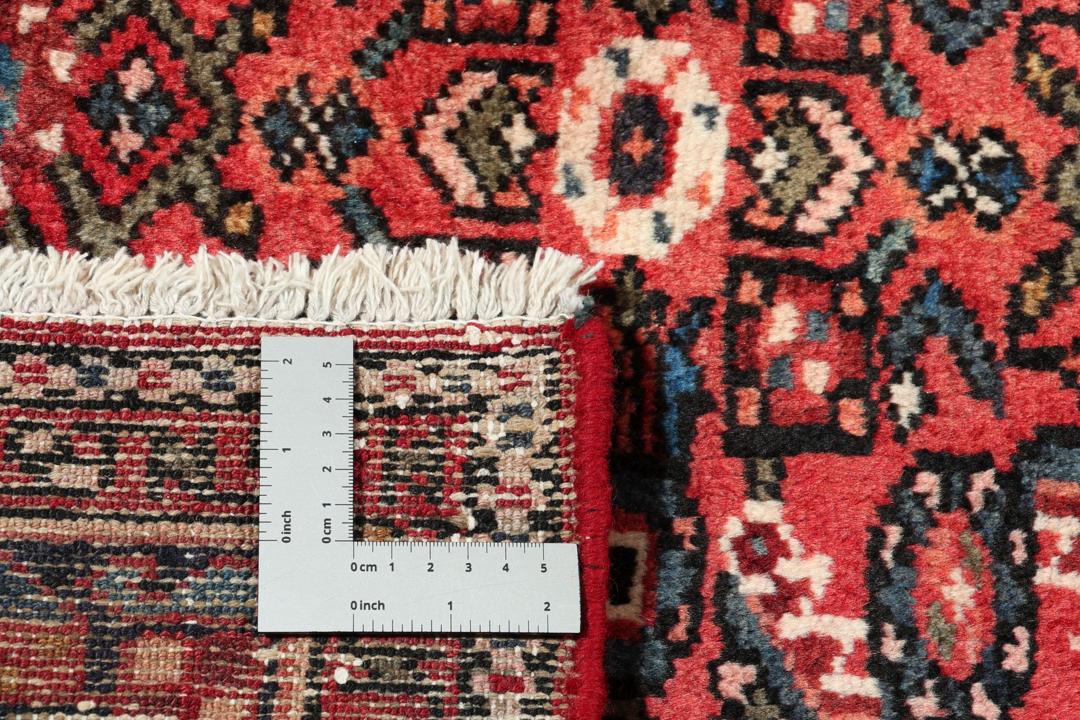 Handmade Hosseinabad runner from the Middle East with a vibrant red Wool pile