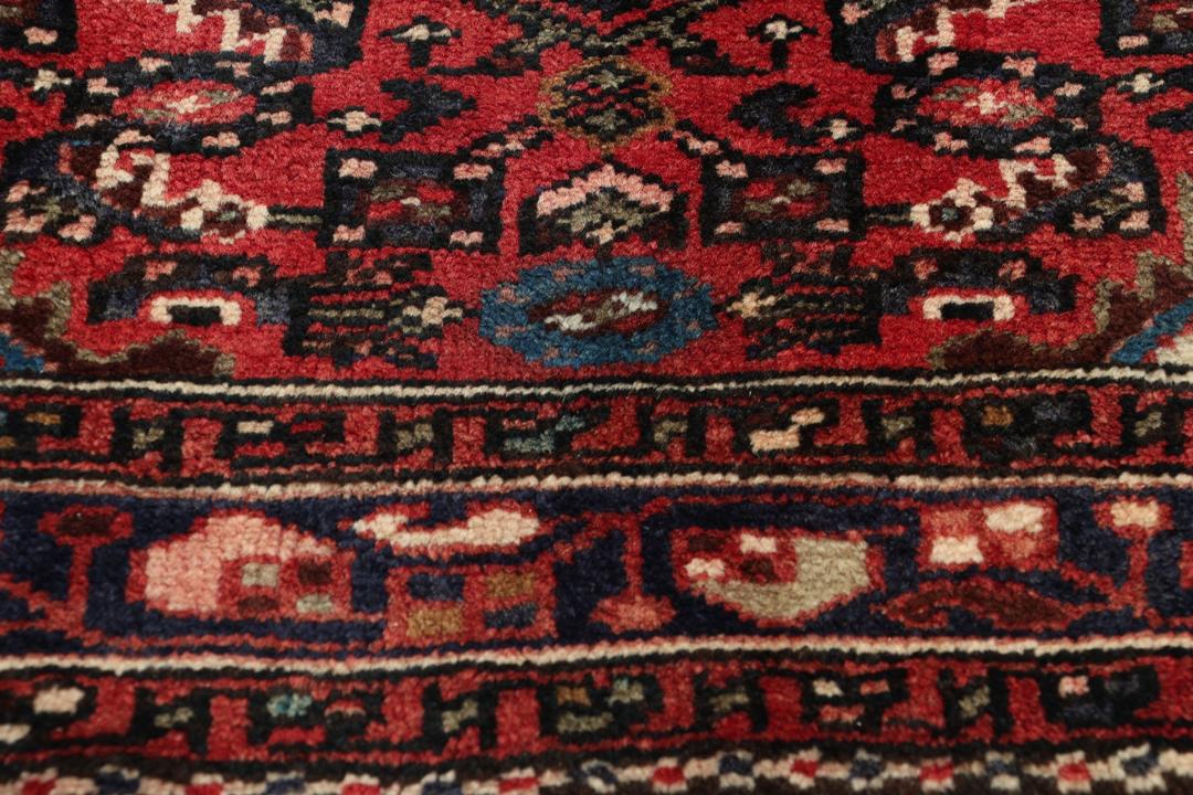 Handmade Hosseinabad runner from the Middle East with a vibrant red Wool pile