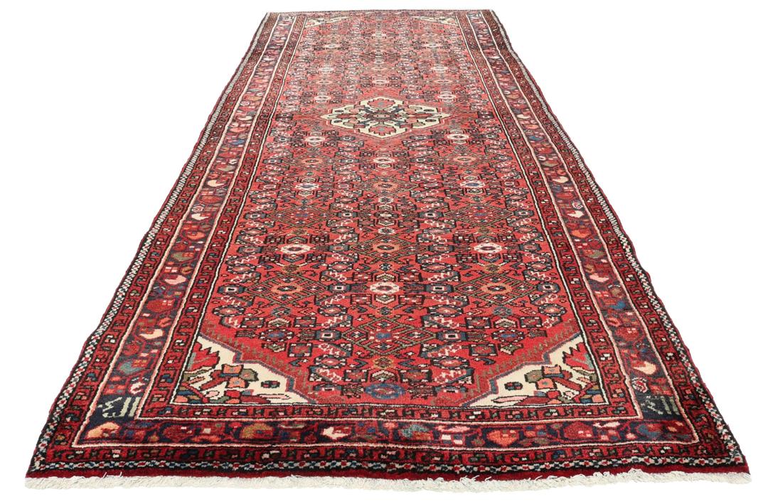 Handmade Hosseinabad runner from the Middle East with a vibrant red Wool pile