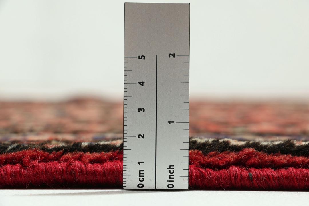 Handmade Hosseinabad runner from the Middle East with a vibrant red Wool pile