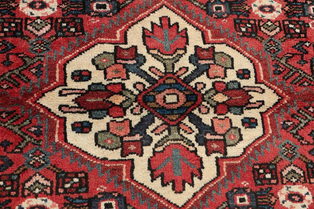 Handmade Hosseinabad runner from the Middle East with a vibrant red Wool pile