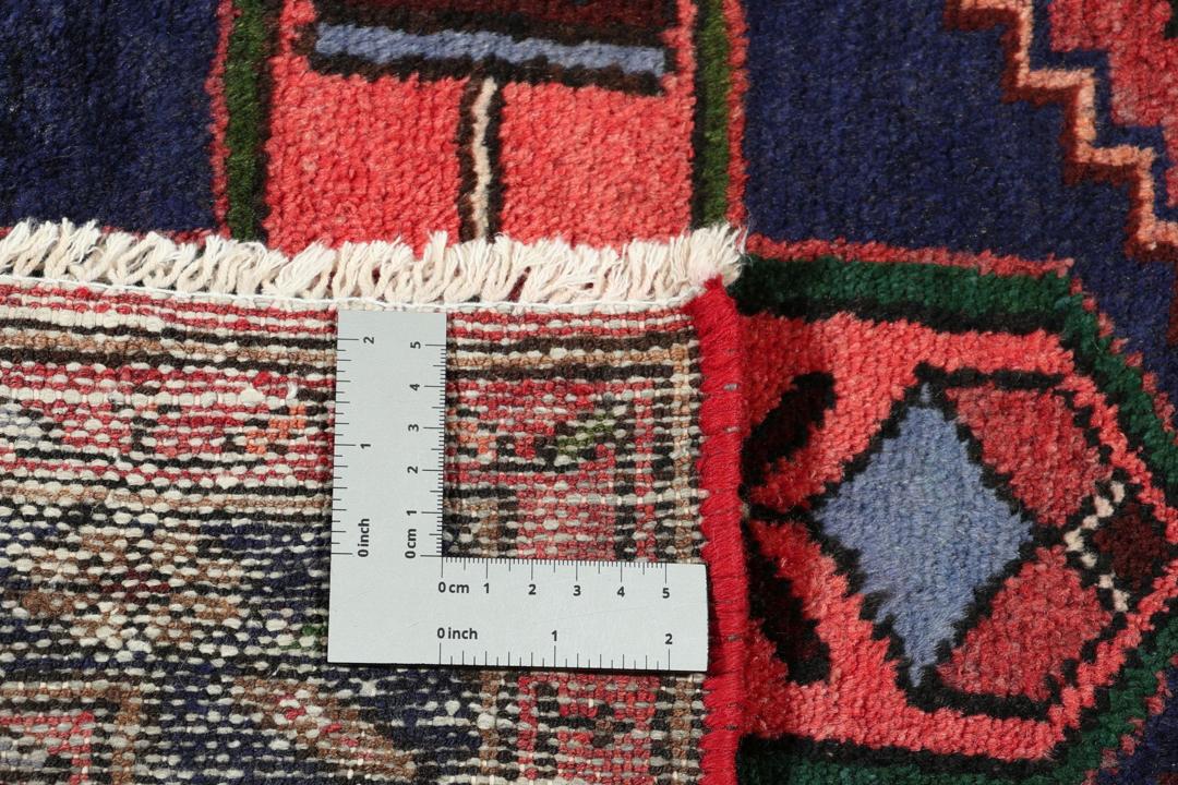 A hand-knotted Hamadan rug from the Middle East featuring a dark-blue and red geometric pattern.