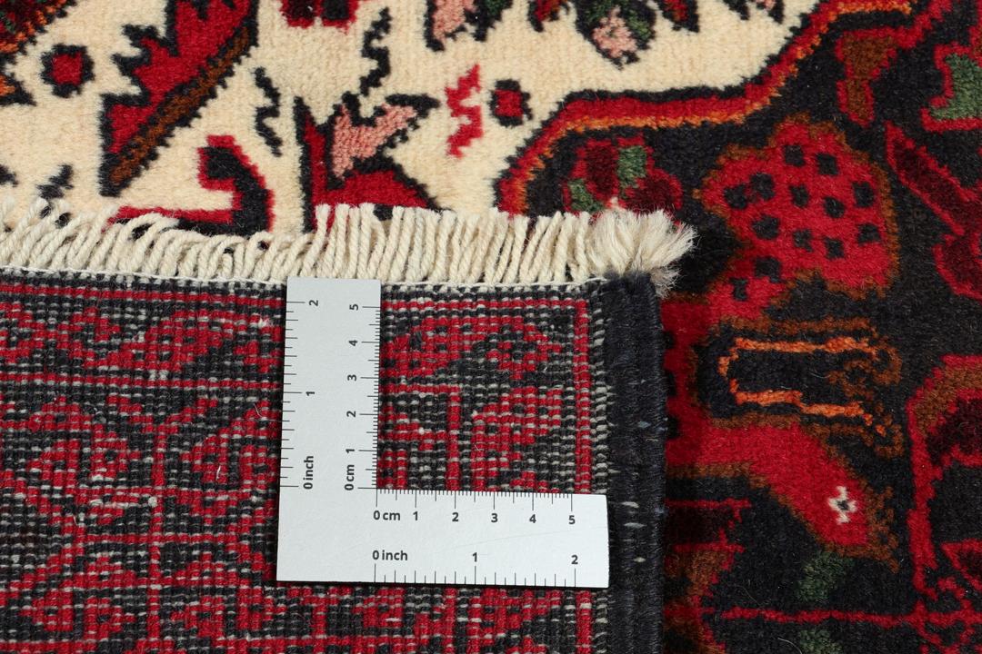 Handgeknoopt Beluch-tapijt in rood en blauw met traditionele tribale patronen