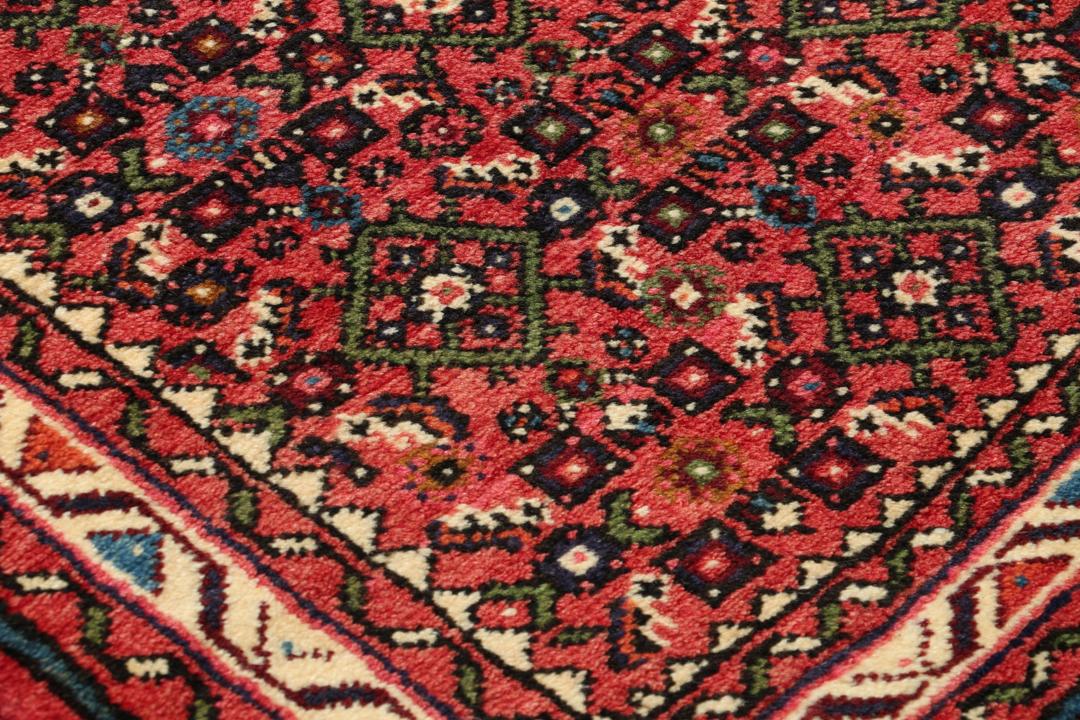 Hand-knotted Hosseinabad runner from the Middle East in shades of red