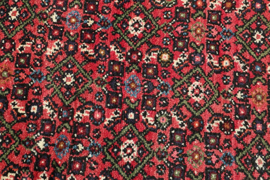 Hand-knotted Hosseinabad runner from the Middle East in shades of red