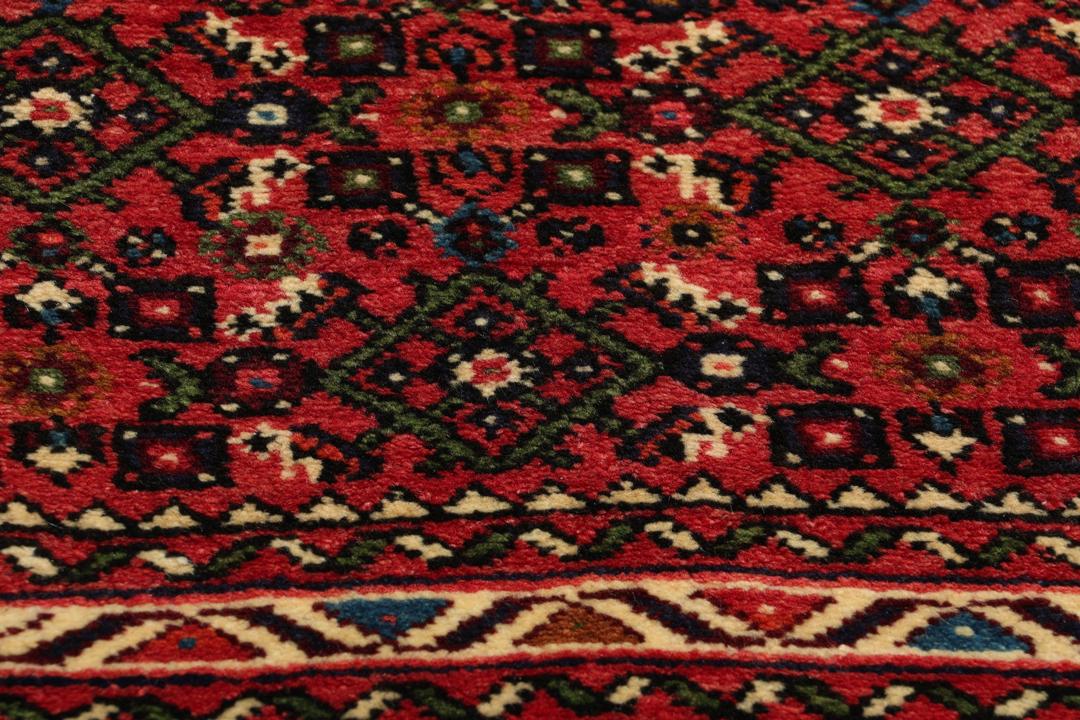 Hand-knotted Hosseinabad runner from the Middle East in shades of red