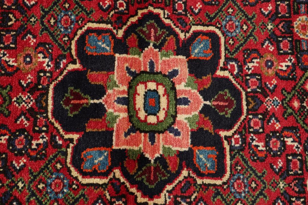 Handmade Hosseinabad runner from the Middle East featuring a vibrant red field