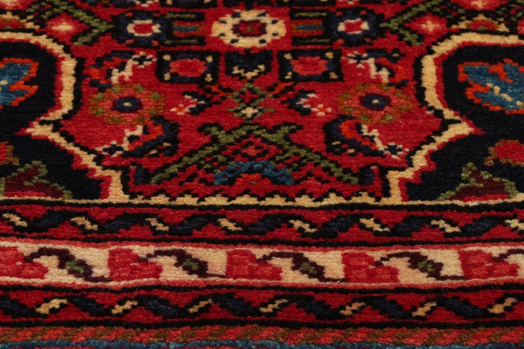 Handmade Hosseinabad runner from the Middle East featuring a vibrant red field
