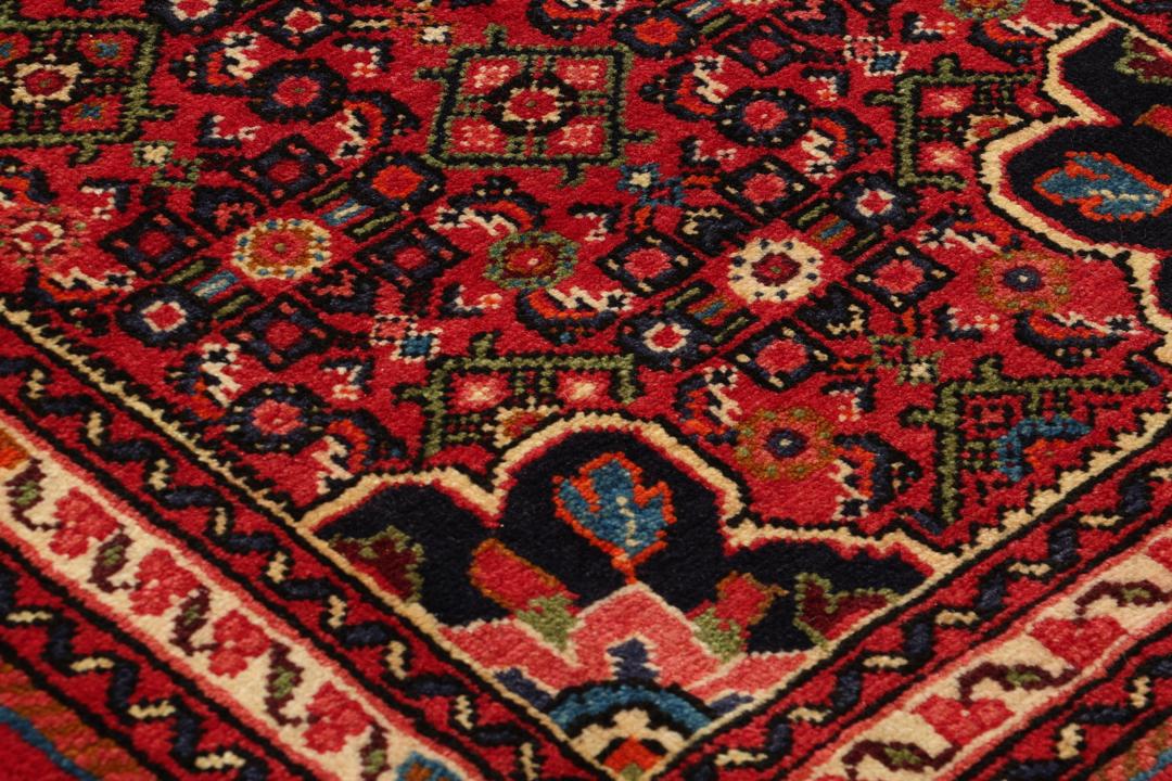 Handmade Hosseinabad runner from the Middle East featuring a vibrant red field