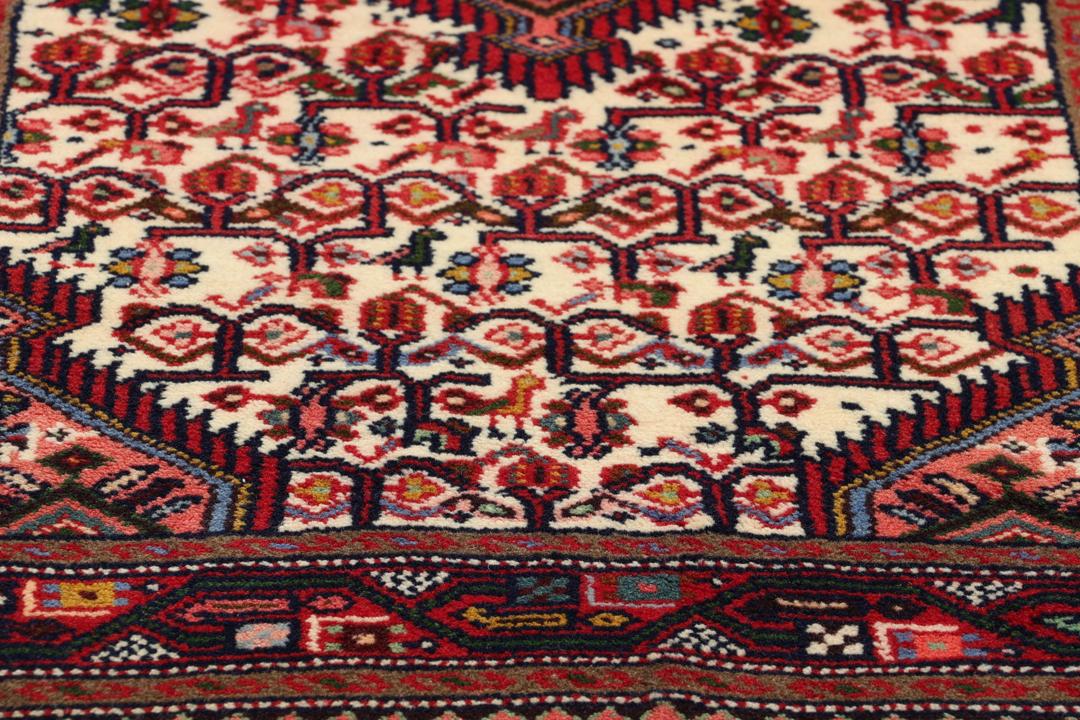 Hand-knotted runner from the Middle East in a deep red and beige palette