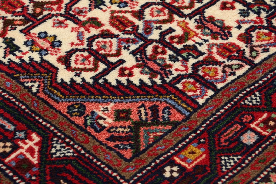 Hand-knotted runner from the Middle East in a deep red and beige palette