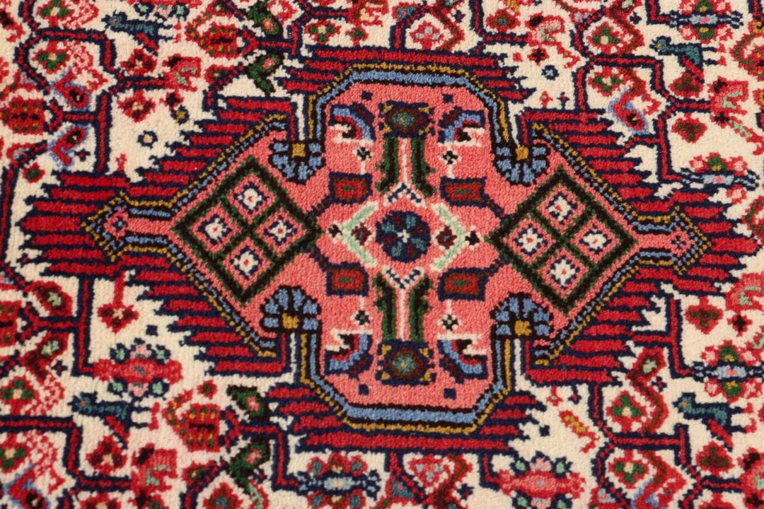 Hand-knotted runner from the Middle East in a deep red and beige palette