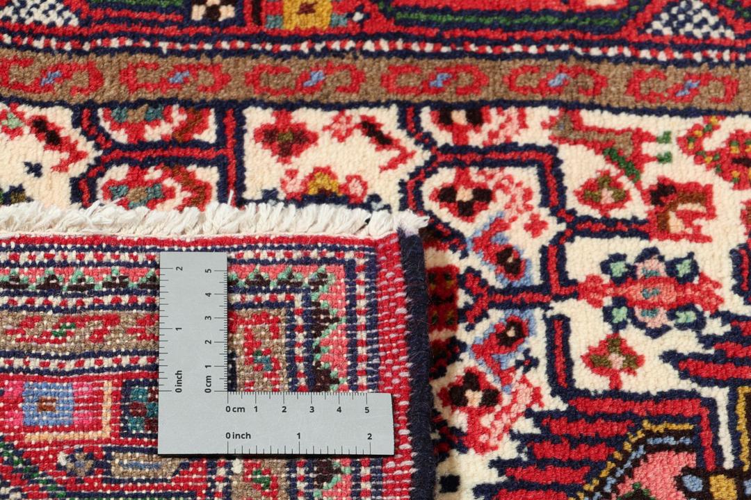 Hand-knotted runner from the Middle East in a deep red and beige palette