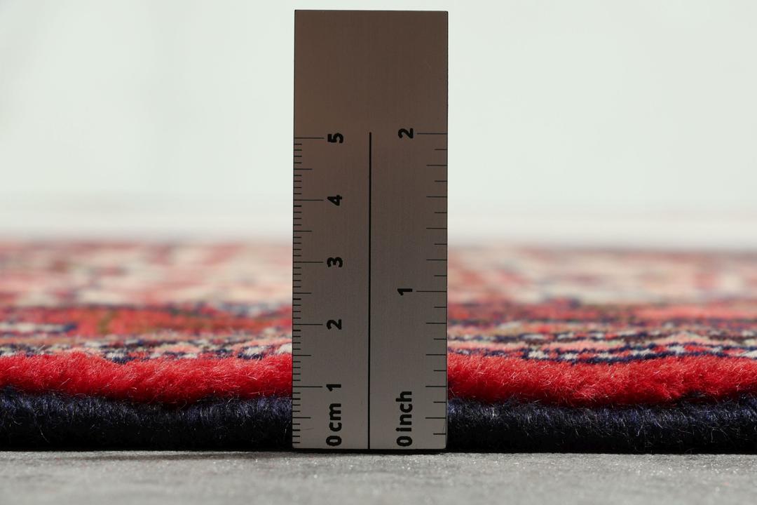 Hand-knotted runner from the Middle East in a deep red and beige palette