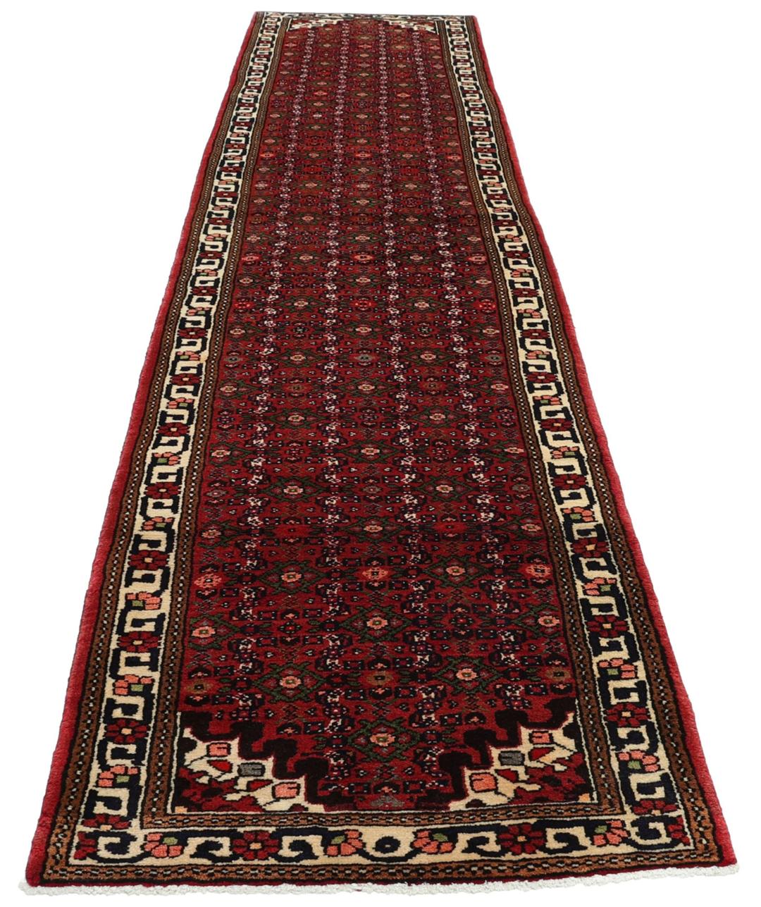 A long, hand-knotted Hosseinabad runner with a red field and traditional geometric motifs.