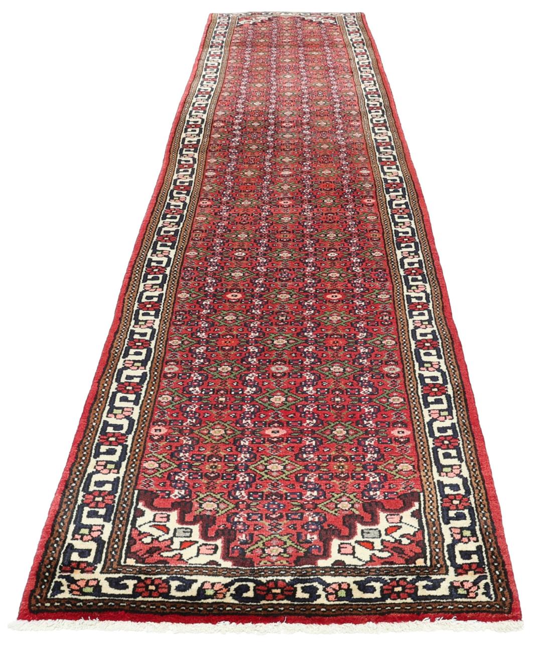 A long, hand-knotted Hosseinabad runner with a red field and traditional geometric motifs.