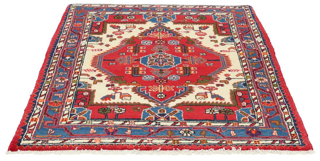 Hand-knotted Toiserkan rug from the Middle East in vibrant red and blue tones