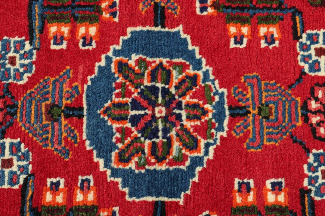 Hand-knotted Toiserkan rug from the Middle East in vibrant red and blue tones
