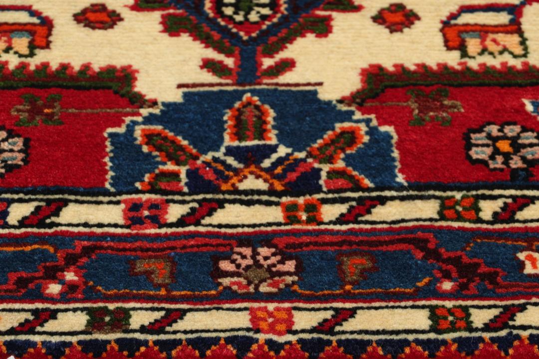 Hand-knotted Toiserkan rug from the Middle East in vibrant red and blue tones