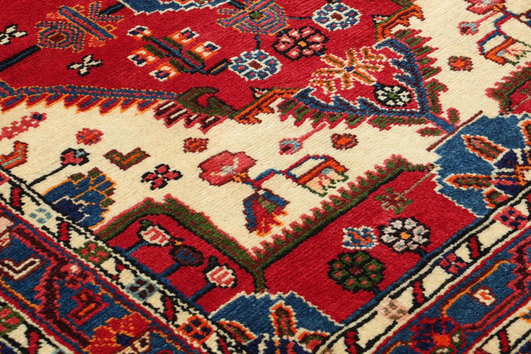 Hand-knotted Toiserkan rug from the Middle East in vibrant red and blue tones