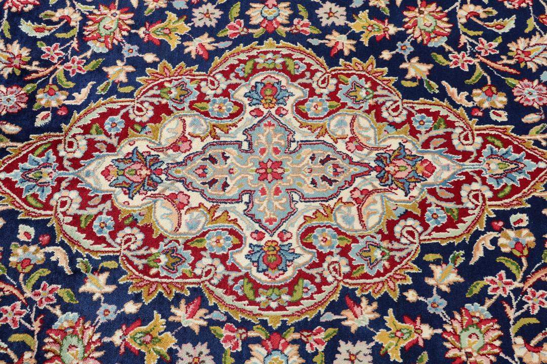 Hand-knotted Kerman rug with a blue and red floral medallion design from the Middle East.