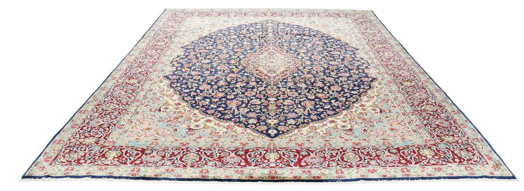 Hand-knotted Kerman rug with a blue and red floral medallion design from the Middle East.