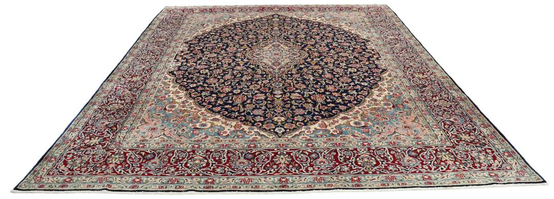 Hand-knotted Kerman rug with a blue and red floral medallion design from the Middle East.