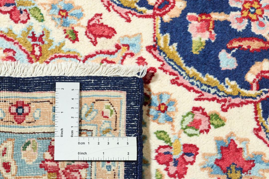 Hand-knotted Kerman rug with a blue and red floral medallion design from the Middle East.