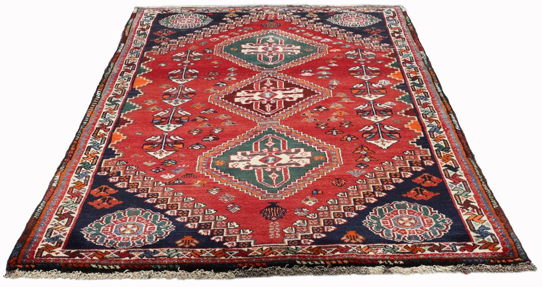 Handgeknoopt Shiraz-tapijt uit het Midden-Oosten met een levendig rood en blauw geometrisch ontwerp.