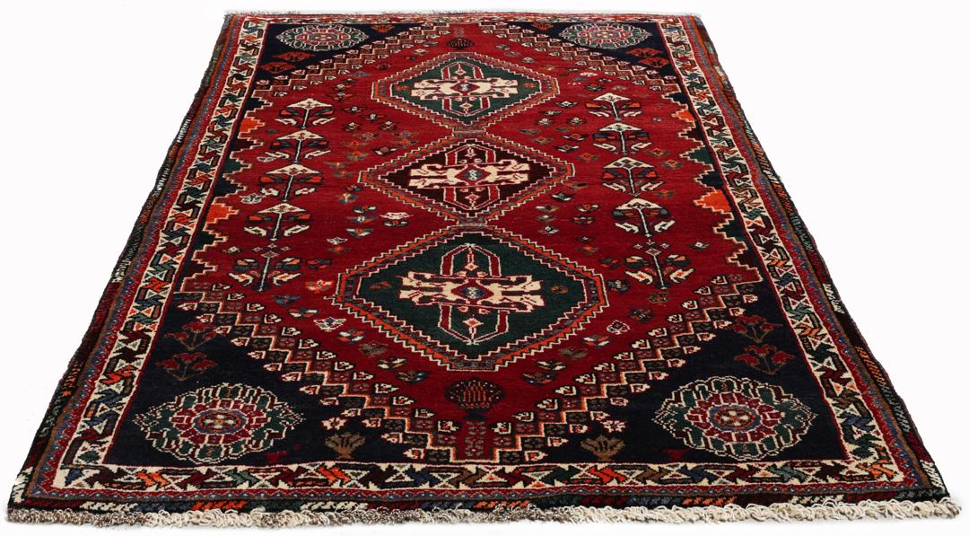 Handgeknoopt Shiraz-tapijt uit het Midden-Oosten met een levendig rood en blauw geometrisch ontwerp.