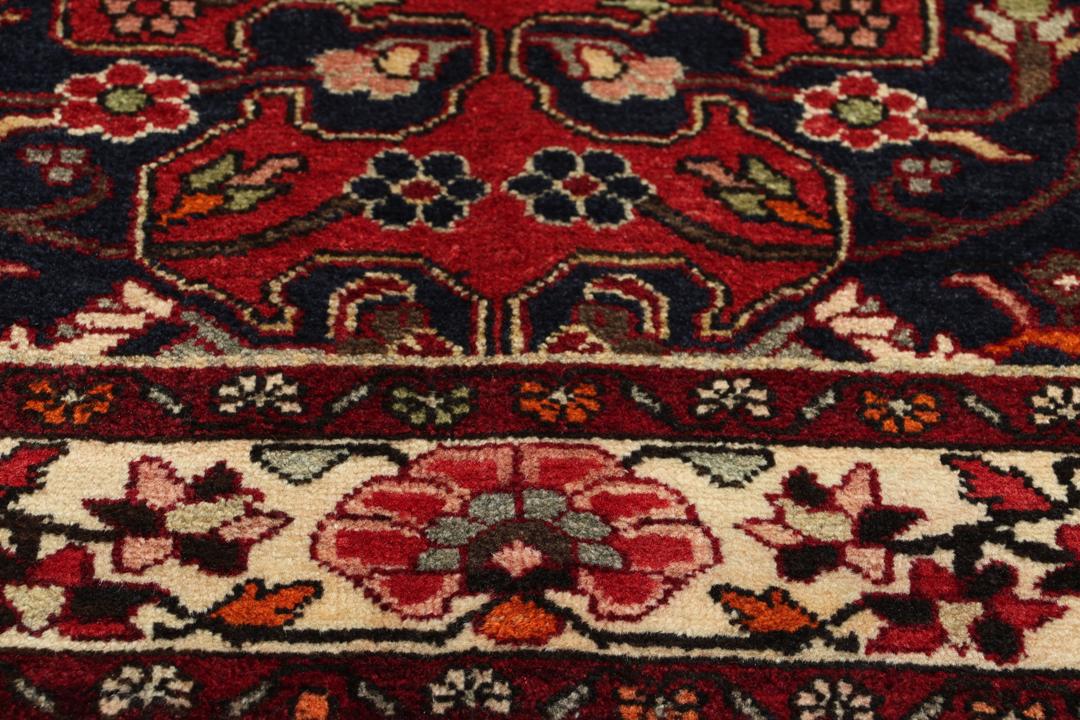 Hand-knotted Tafresch Wool rug from the Middle East featuring a red and blue floral design