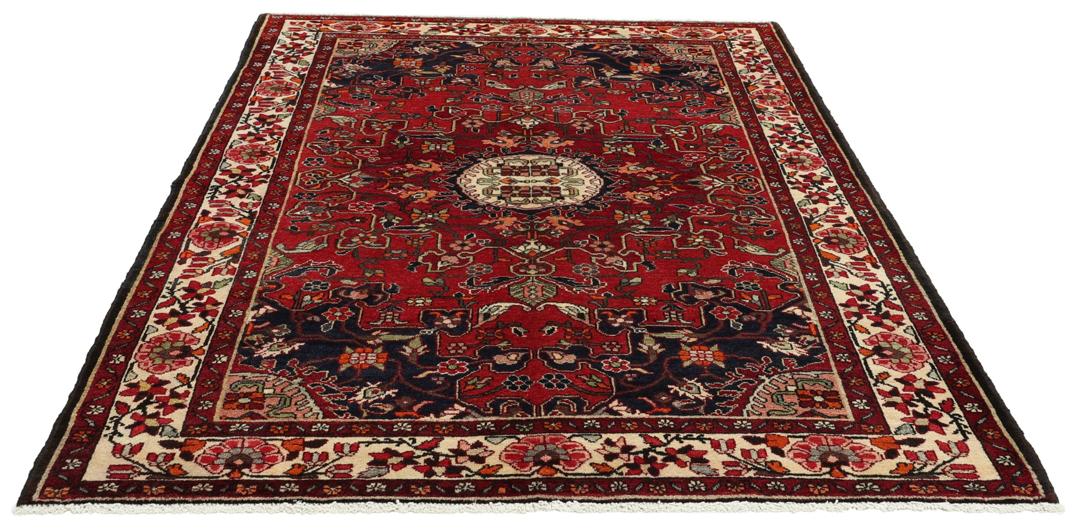 Hand-knotted Tafresch Wool rug from the Middle East featuring a red and blue floral design