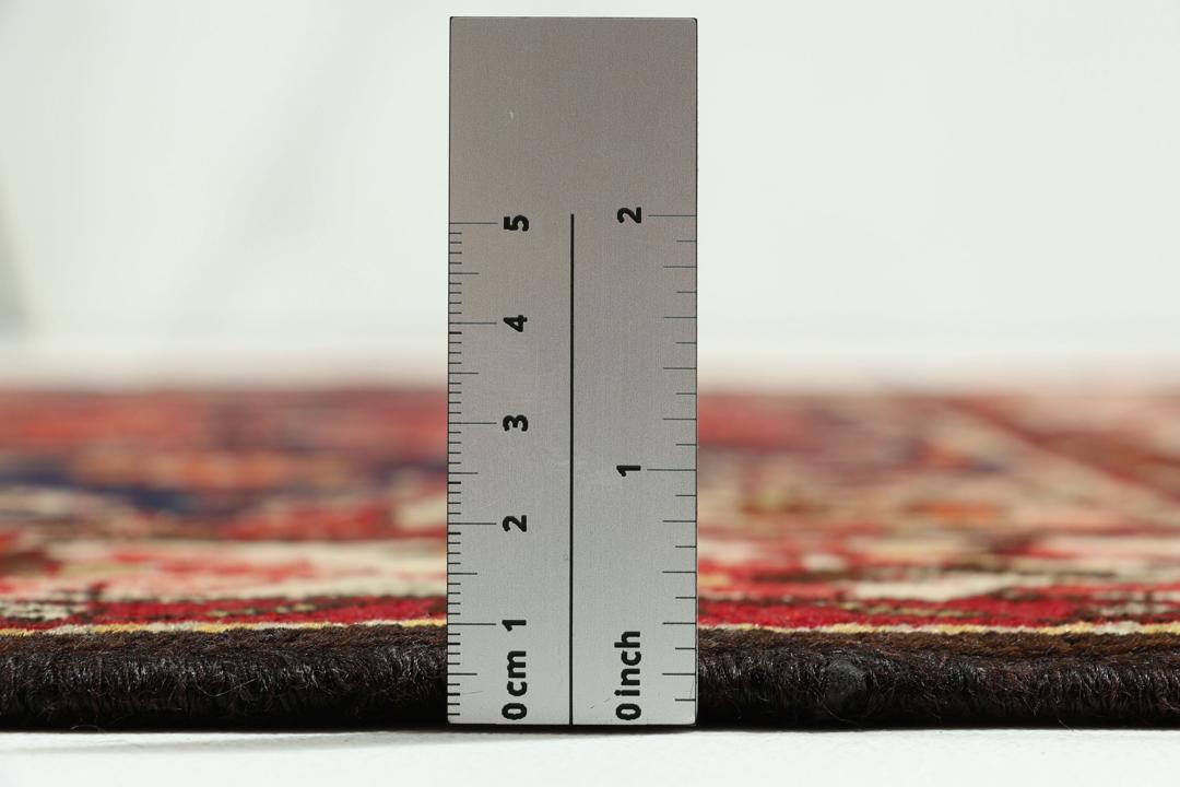 Hand-knotted Tafresch Wool rug from the Middle East featuring a red and blue floral design