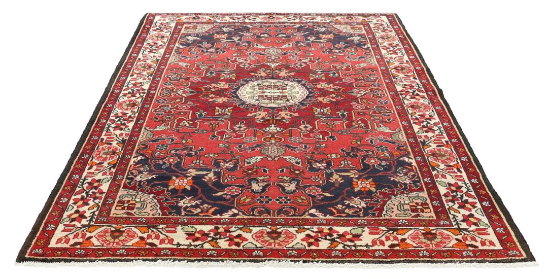 Hand-knotted Tafresch Wool rug from the Middle East featuring a red and blue floral design