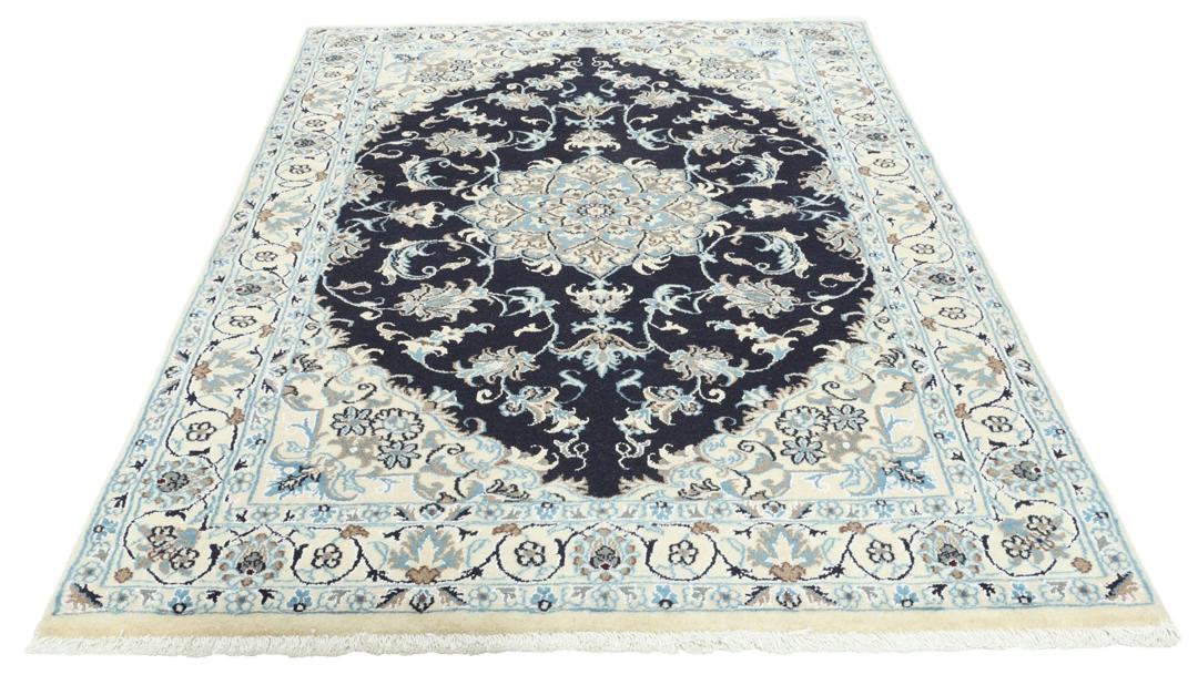 A sophisticated hand-knotted Nain rug from the Middle East with a dark-blue and beige floral pattern.