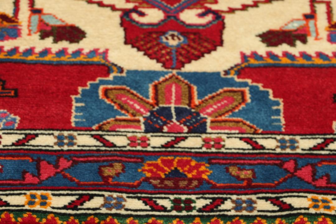 Hand-knotted Hamadan rug featuring a red field with blue and cream geometric motifs