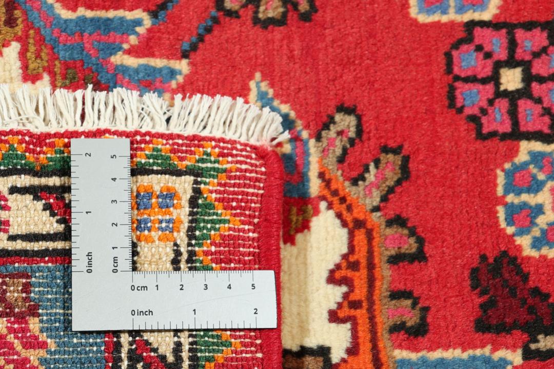 Hand-knotted Hamadan rug featuring a red field with blue and cream geometric motifs