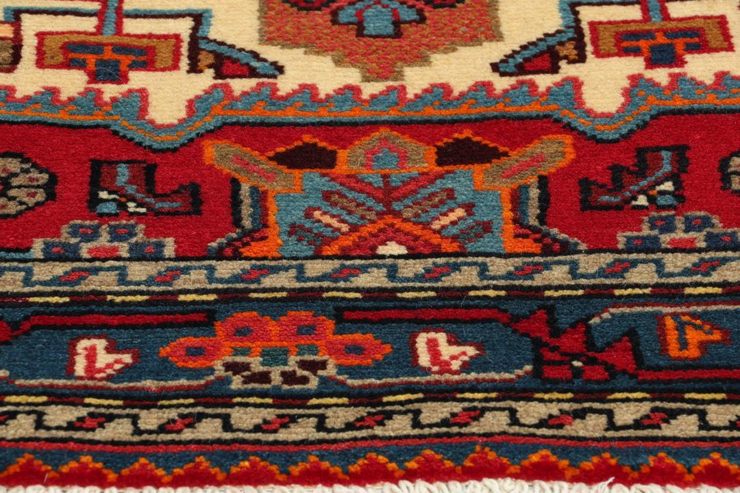 A hand-knotted Hamadan rug from the Middle East featuring a vibrant red and blue geometric design.