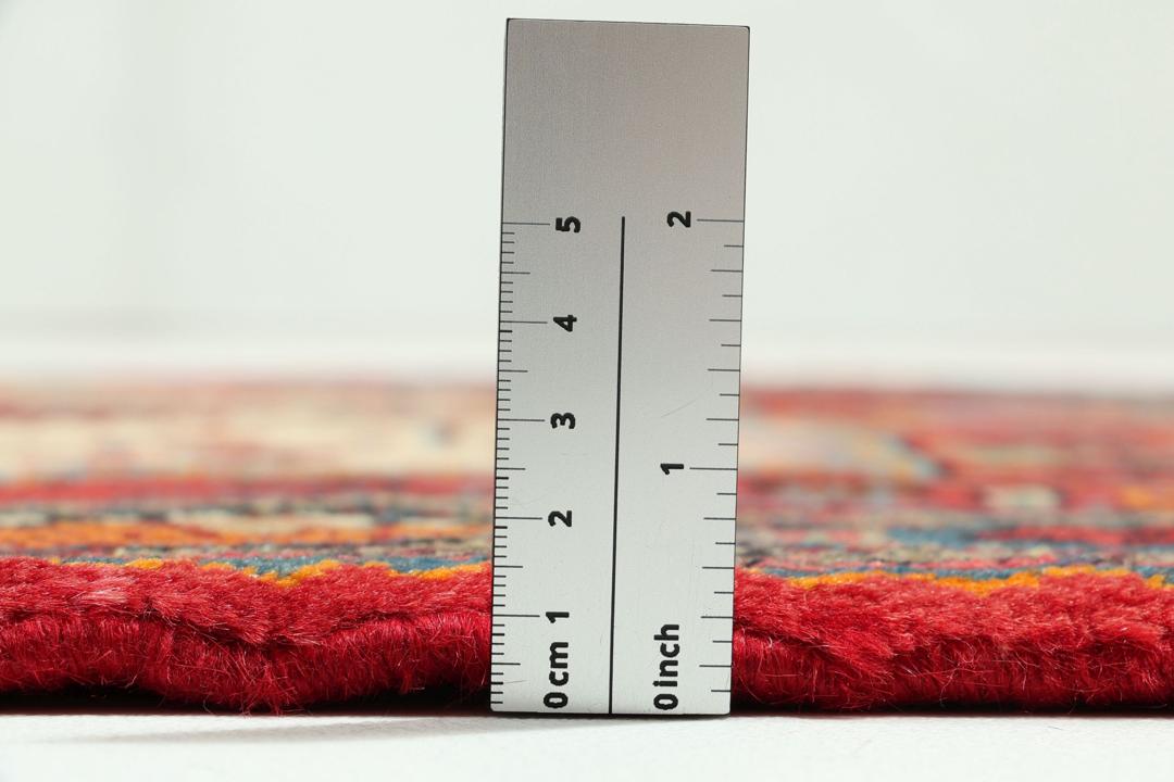 A hand-knotted Hamadan rug from the Middle East featuring a vibrant red and blue geometric design.