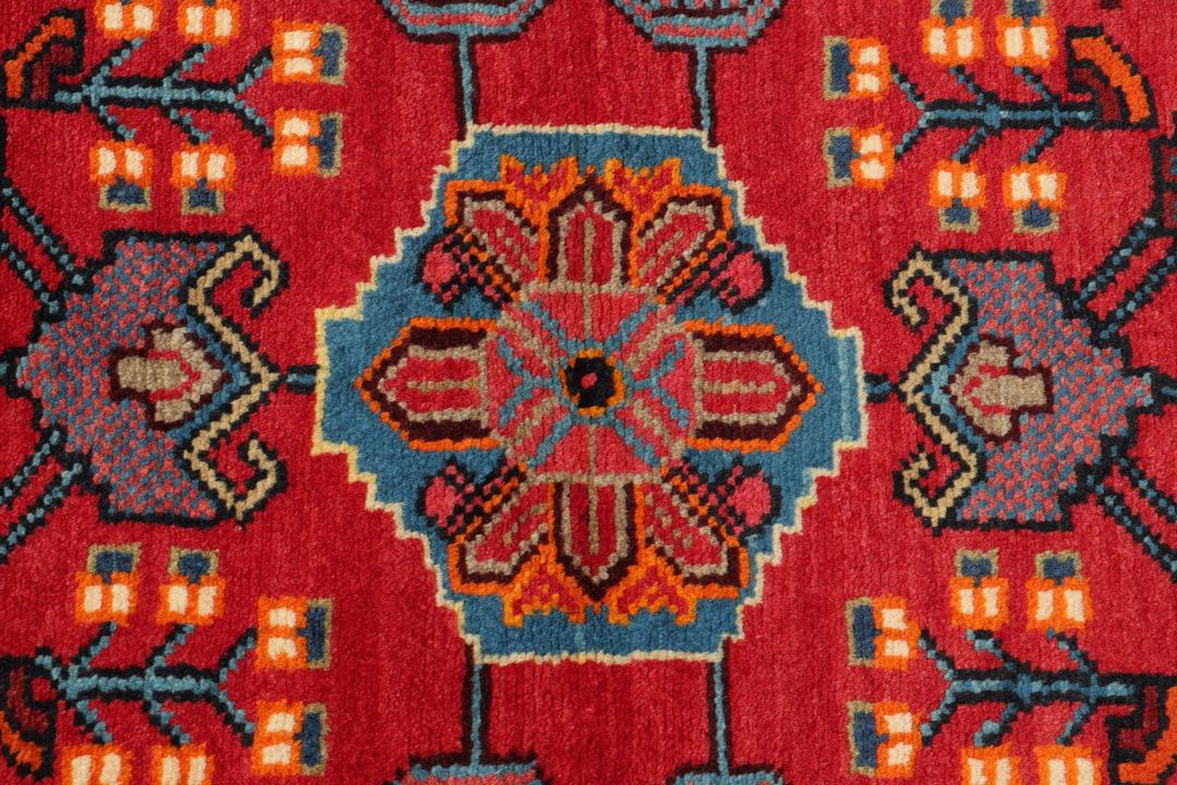 A hand-knotted Hamadan rug from the Middle East featuring a vibrant red and blue geometric design.