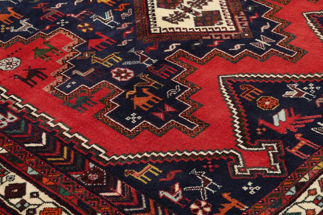 Hand-knotted Afshar rug from the Middle East featuring a red and blue tribal design.