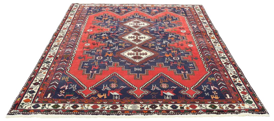 Hand-knotted Afshar rug from the Middle East featuring a red and blue tribal design.