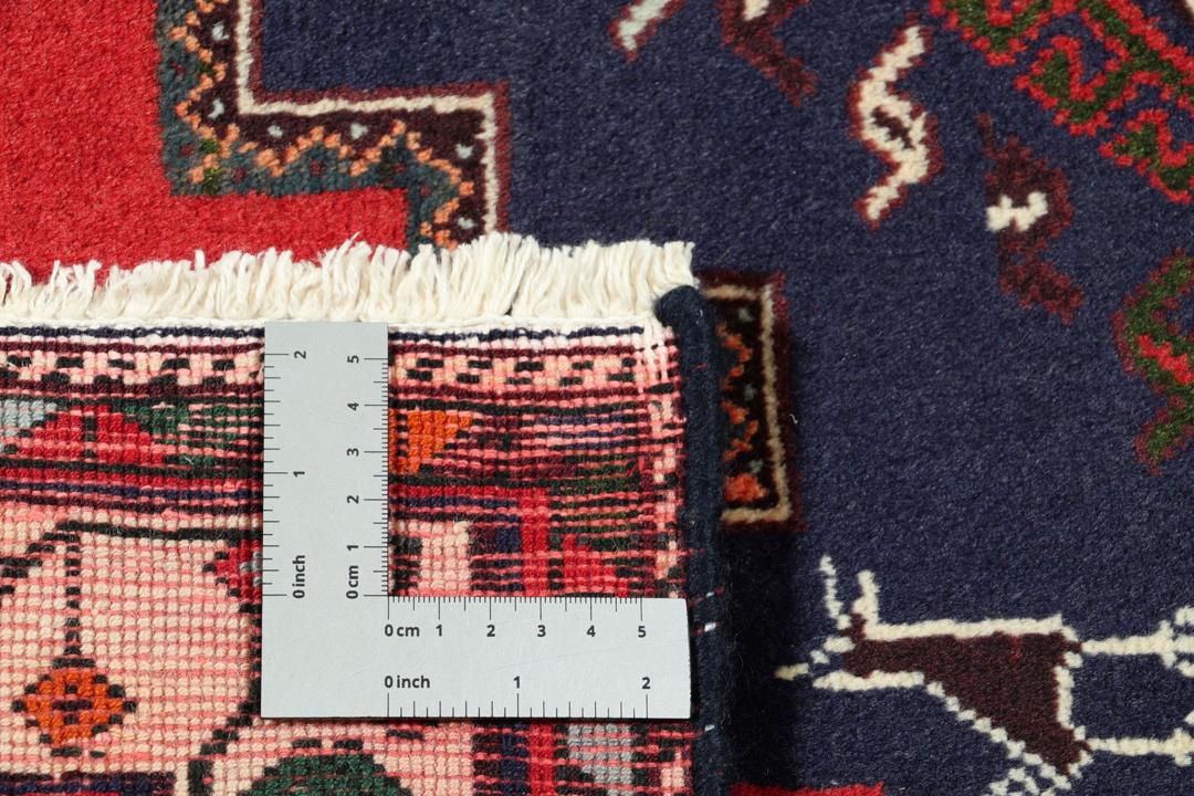 Hand-knotted Afshar rug from the Middle East featuring a red and blue tribal design.
