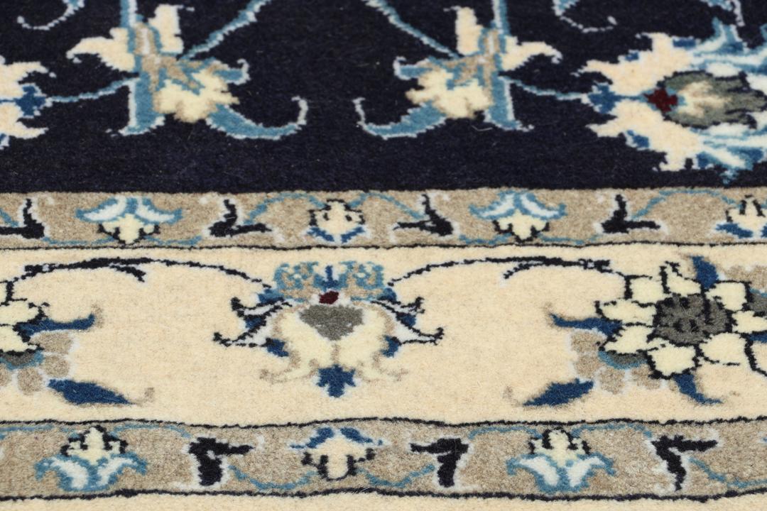 Hand-knotted Nain rug from the Middle East in dark blue and beige tones.