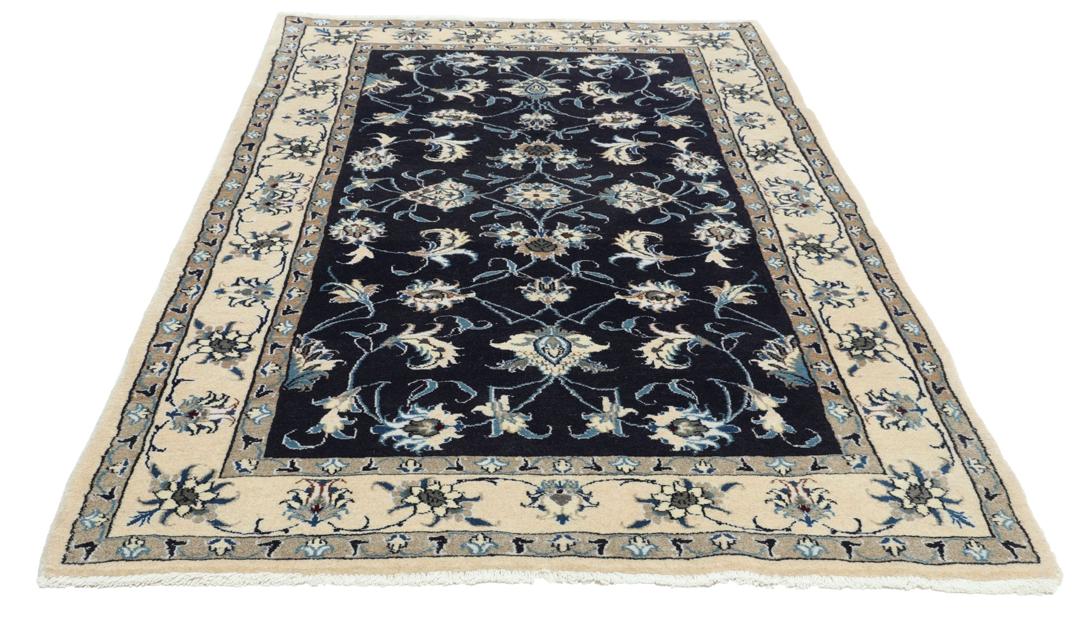 Hand-knotted Nain rug from the Middle East in dark blue and beige tones.