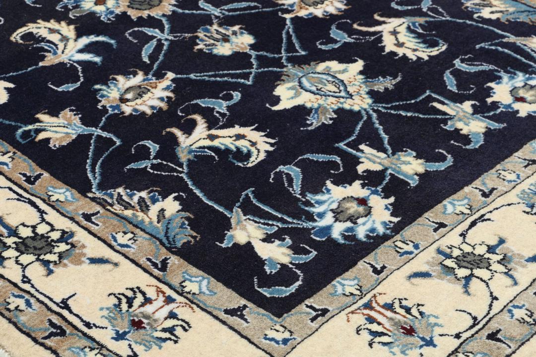 Hand-knotted Nain rug from the Middle East in dark blue and beige tones.