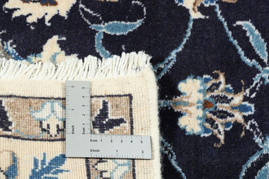 Hand-knotted Nain rug from the Middle East in dark blue and beige tones.