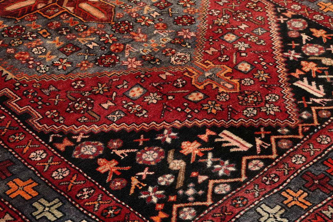 Hand-knotted Middle Eastern rug in multicolor featuring traditional geometric motifs