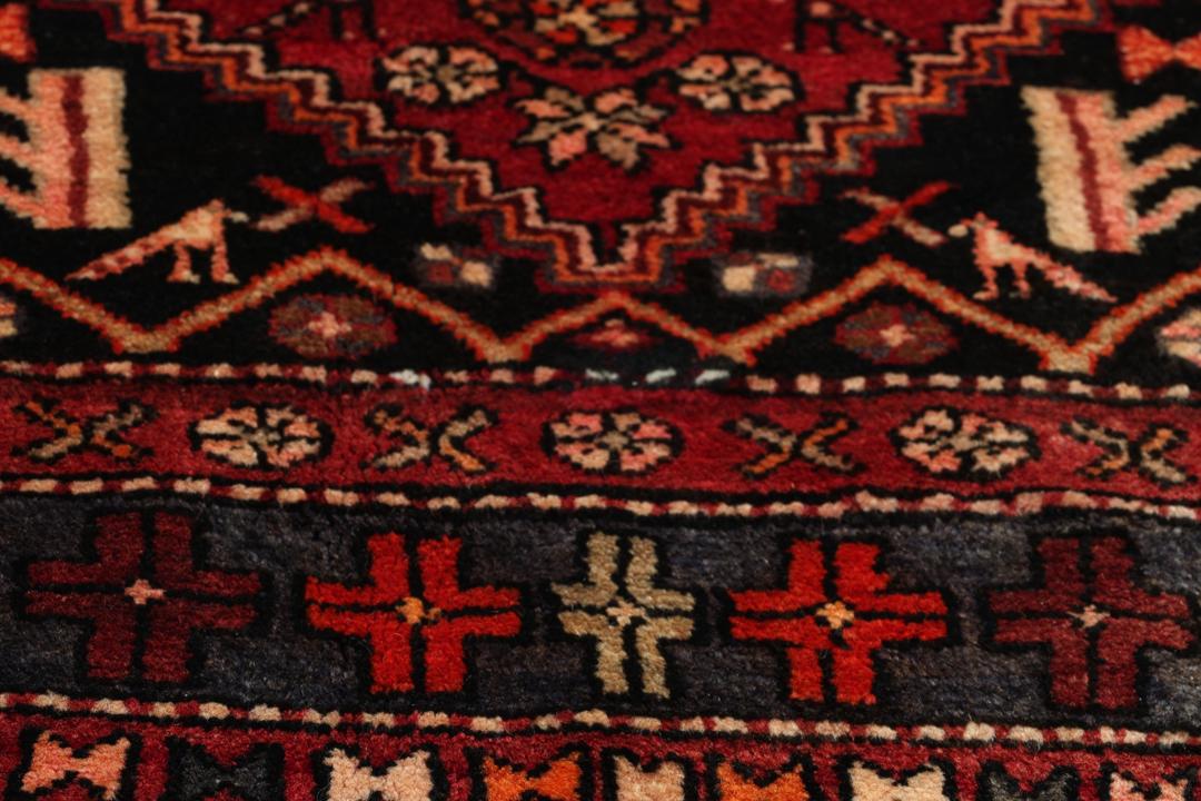 Hand-knotted Middle Eastern rug in multicolor featuring traditional geometric motifs